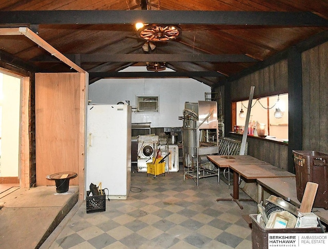 interior space featuring tile patterned floors and freestanding refrigerator