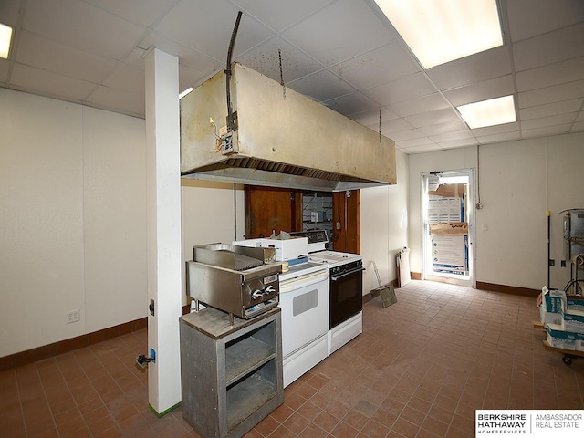 kitchen featuring a paneled ceiling, electric stove, and baseboards