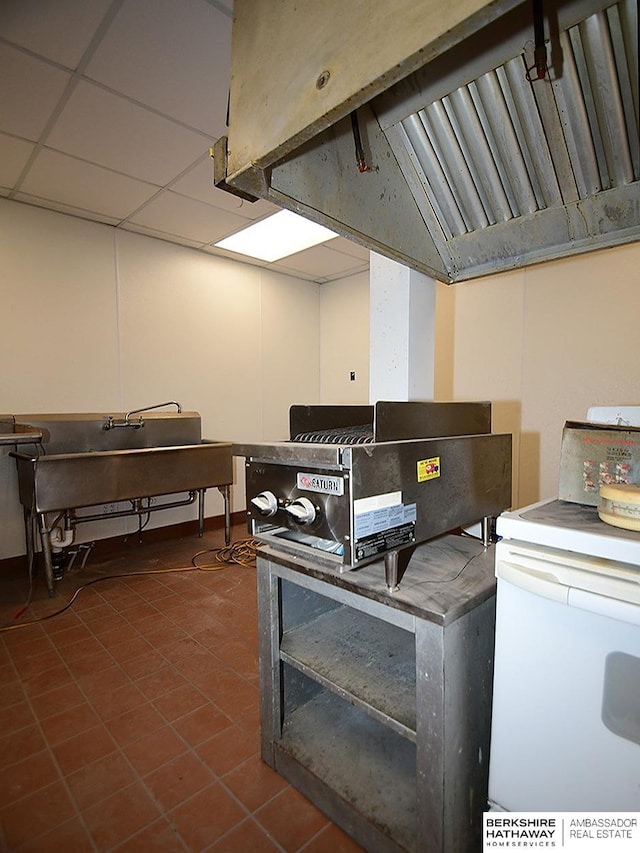 misc room with a paneled ceiling and tile patterned floors