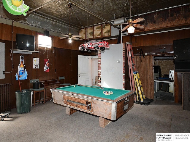 playroom with an ornate ceiling, wood walls, radiator heating unit, and ceiling fan