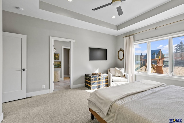 bedroom with light carpet, baseboards, a raised ceiling, ceiling fan, and recessed lighting