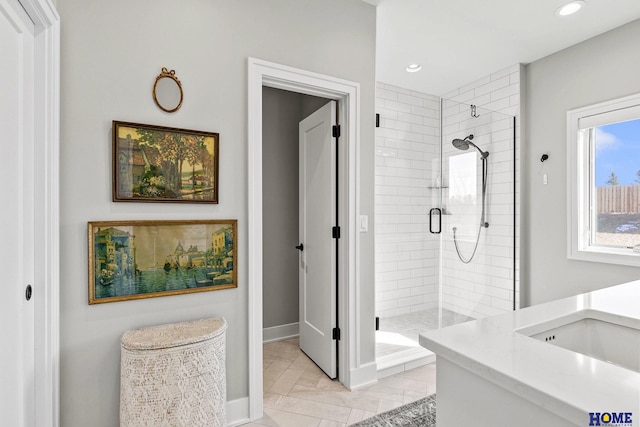 bathroom with baseboards, a shower stall, and recessed lighting