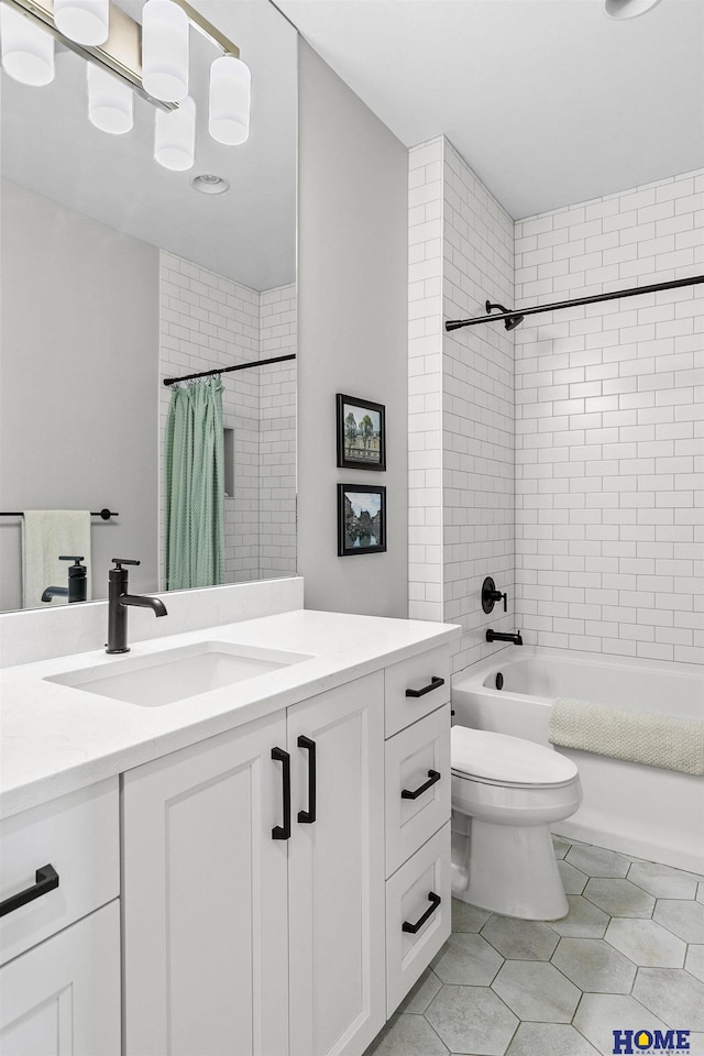 full bath featuring tile patterned flooring, shower / tub combo with curtain, vanity, and toilet