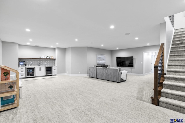 living room with wine cooler, carpet, a dry bar, recessed lighting, and stairs