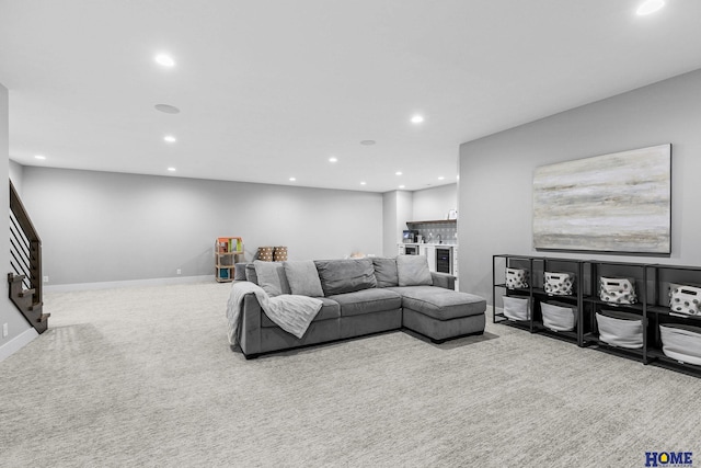 living room with recessed lighting, light carpet, and baseboards