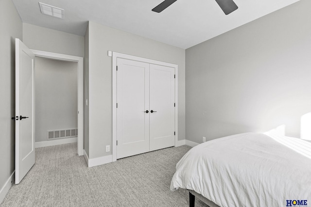 bedroom with light colored carpet, a closet, visible vents, and baseboards