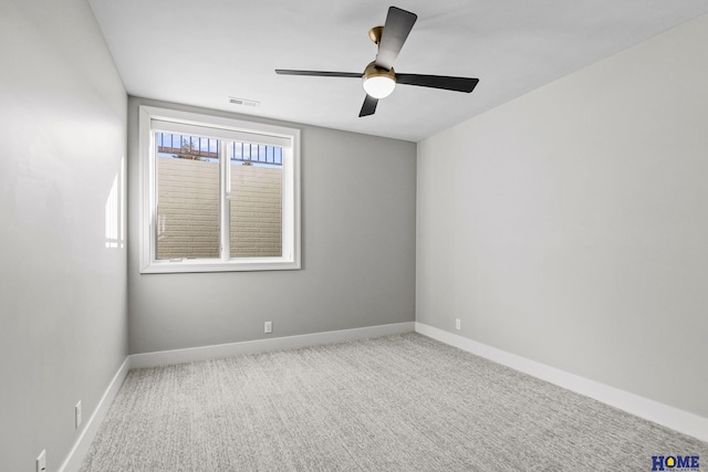 spare room with visible vents, baseboards, ceiling fan, and carpet flooring