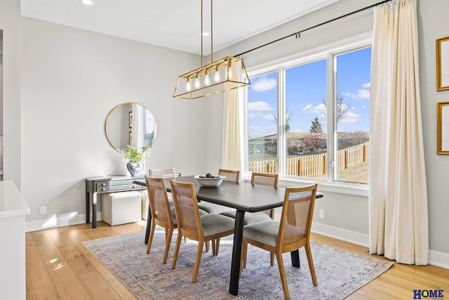 dining room with recessed lighting, light wood-style flooring, and baseboards