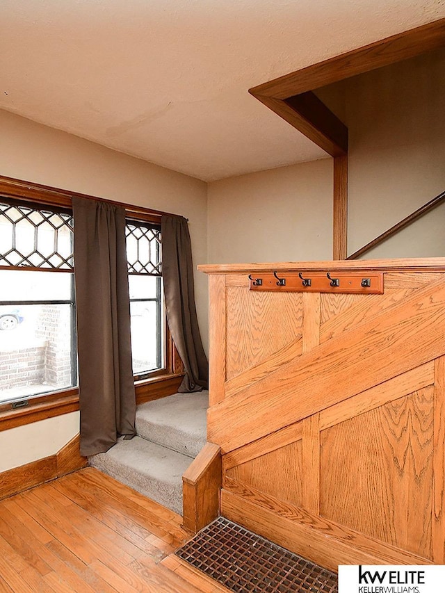 stairway with baseboards and hardwood / wood-style floors