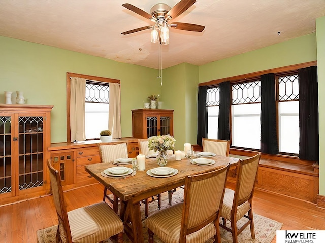 dining room featuring light wood-type flooring and a ceiling fan