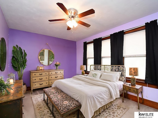 bedroom with a ceiling fan and baseboards