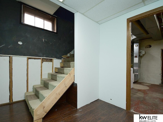 basement featuring stairway and wood finished floors