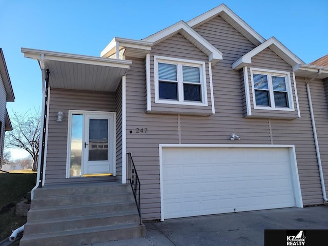 view of front facade with a garage and entry steps