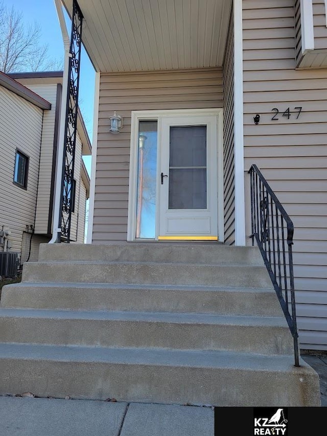 doorway to property featuring central air condition unit