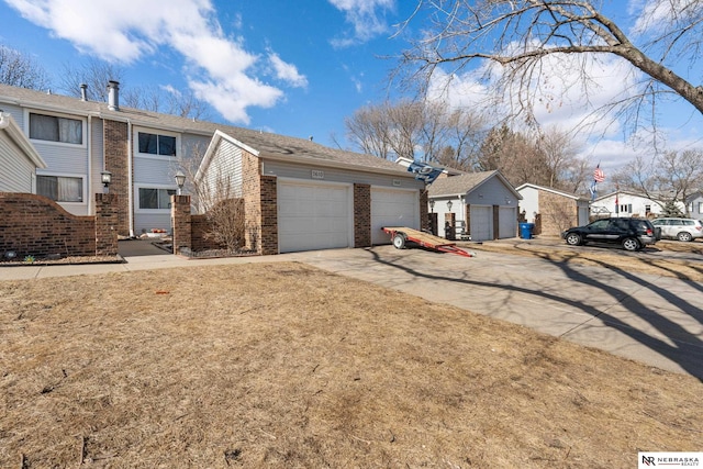 view of front of home with a garage, a front lawn, and brick siding