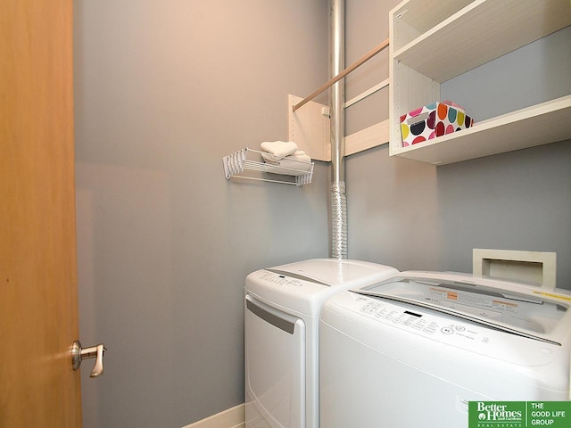 washroom featuring laundry area, washer and clothes dryer, and baseboards