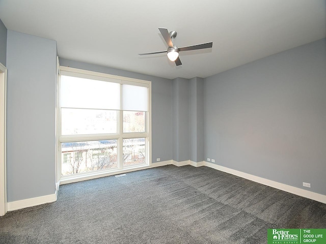 carpeted spare room with ceiling fan, visible vents, and baseboards