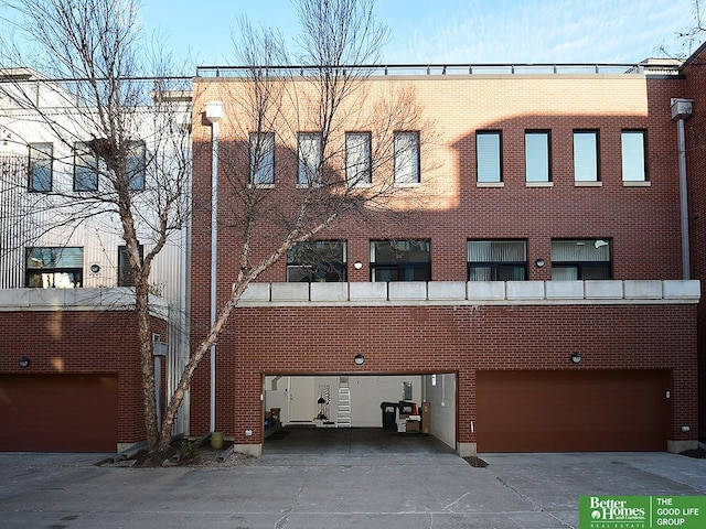 view of property with an attached garage and concrete driveway