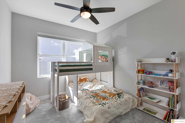 carpeted bedroom with a ceiling fan and baseboards