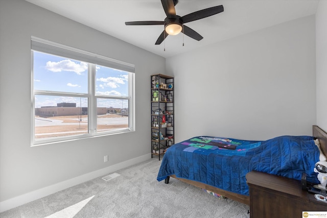 bedroom featuring ceiling fan, carpet, visible vents, and baseboards