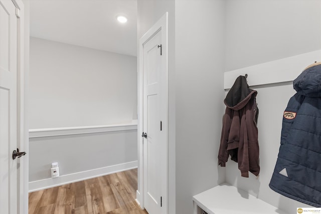 mudroom featuring baseboards and wood finished floors