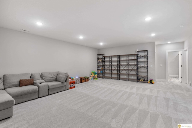 carpeted living area with baseboards and recessed lighting