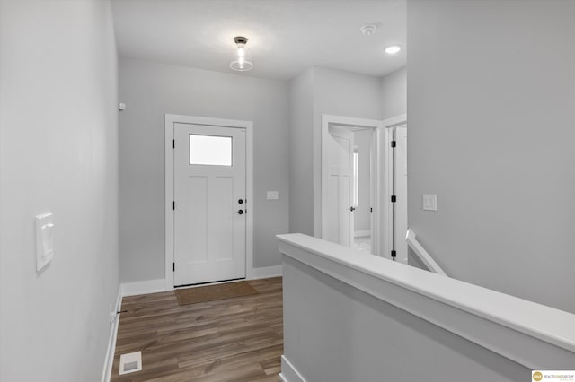 entrance foyer with visible vents, baseboards, and wood finished floors