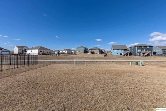 view of yard featuring a residential view and fence