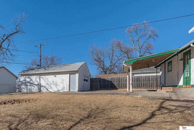 view of yard featuring an outdoor structure and fence