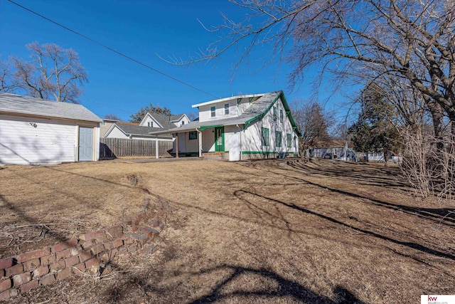 back of house featuring fence