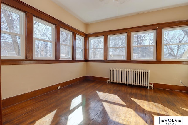 unfurnished sunroom featuring radiator heating unit