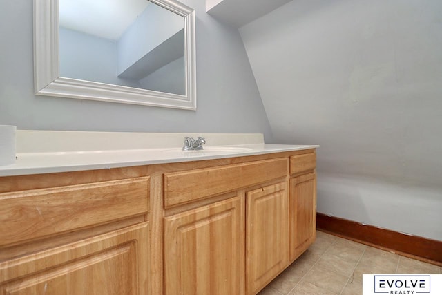 bathroom with tile patterned floors, vanity, and baseboards