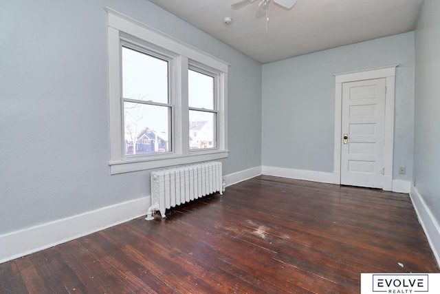 unfurnished room featuring baseboards, ceiling fan, radiator heating unit, and hardwood / wood-style flooring