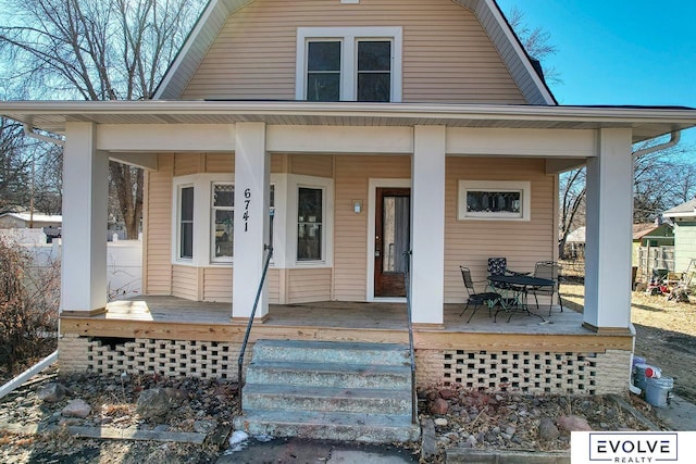 view of front of house featuring a porch and a gambrel roof