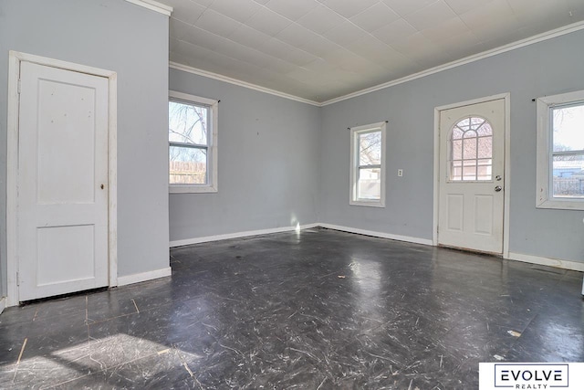 foyer featuring crown molding and baseboards