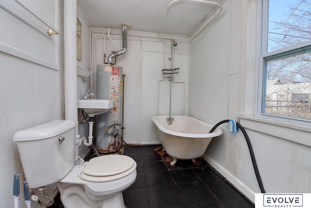 full bathroom with a freestanding tub, water heater, and toilet