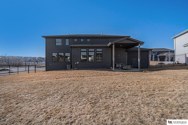 rear view of property with a patio area, fence, and a lawn