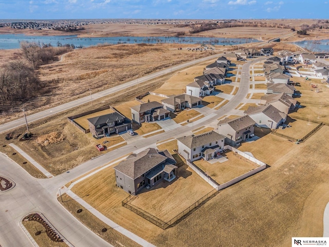 drone / aerial view with a residential view and a water view