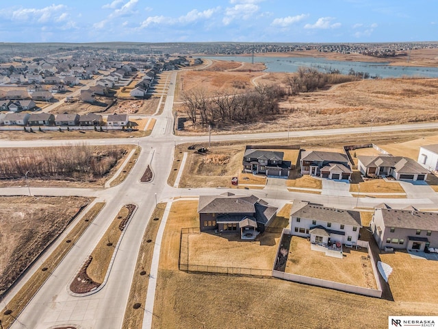 birds eye view of property with a residential view and a water view