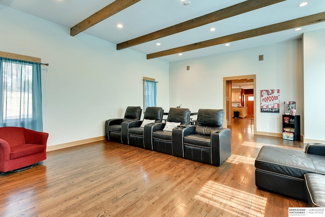 cinema room featuring beam ceiling, recessed lighting, baseboards, and light wood finished floors