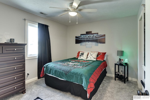 carpeted bedroom featuring visible vents, ceiling fan, a textured ceiling, and baseboards