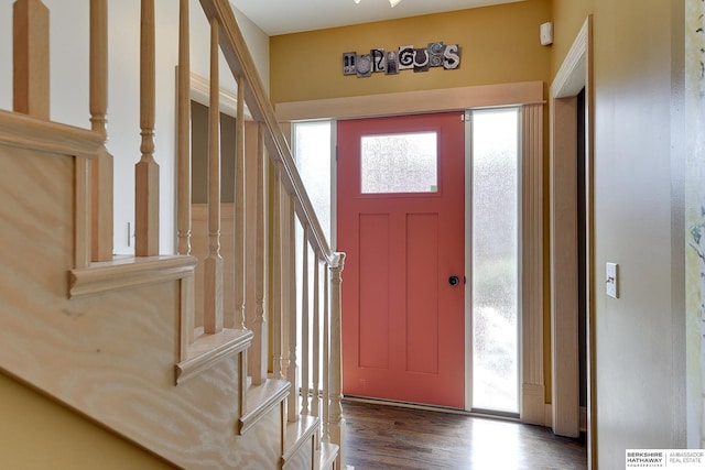 entryway with stairs, wood finished floors, and visible vents