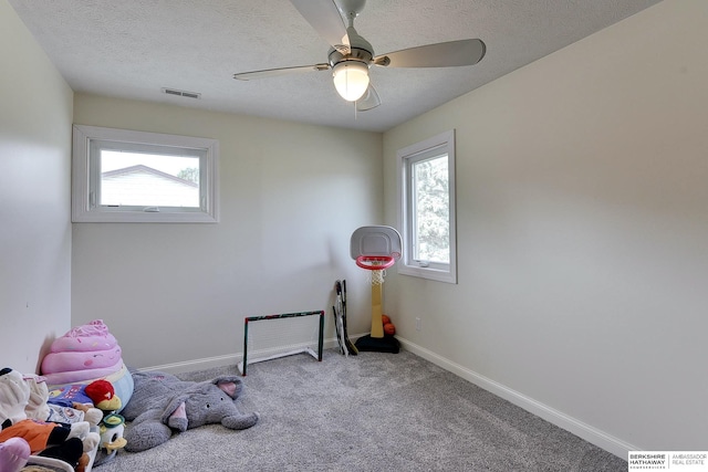 game room featuring visible vents, baseboards, carpet, and a textured ceiling