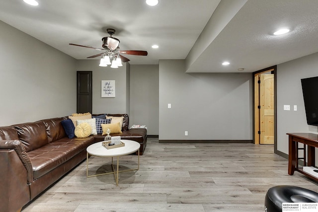 living room with recessed lighting, baseboards, light wood-style floors, and a ceiling fan