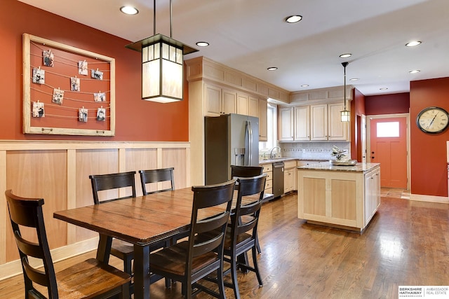 dining room featuring dark wood-type flooring, recessed lighting, visible vents, and a wainscoted wall