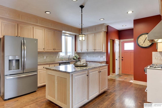 kitchen featuring light brown cabinetry, dishwashing machine, decorative backsplash, and stainless steel fridge with ice dispenser