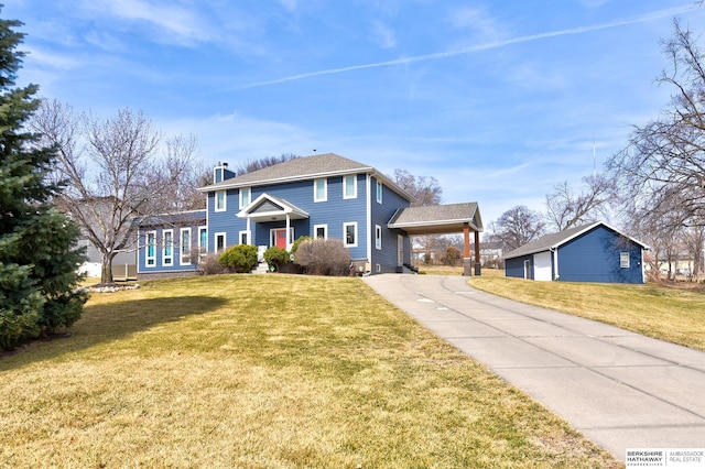 view of front of property featuring an attached carport, concrete driveway, a front yard, and a chimney