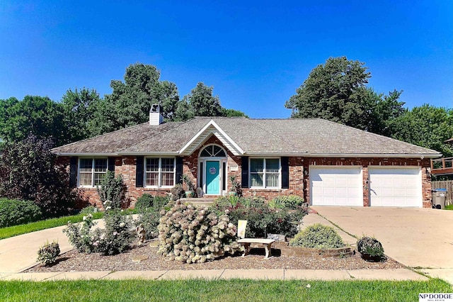 ranch-style house featuring brick siding, a garage, driveway, and a chimney