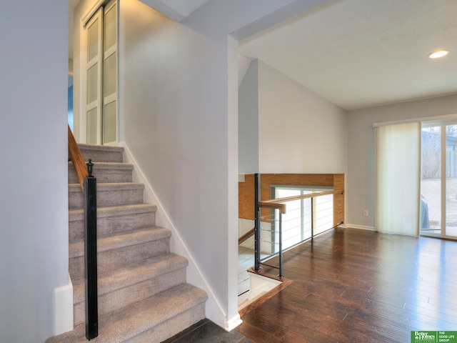 staircase with recessed lighting, baseboards, and wood finished floors