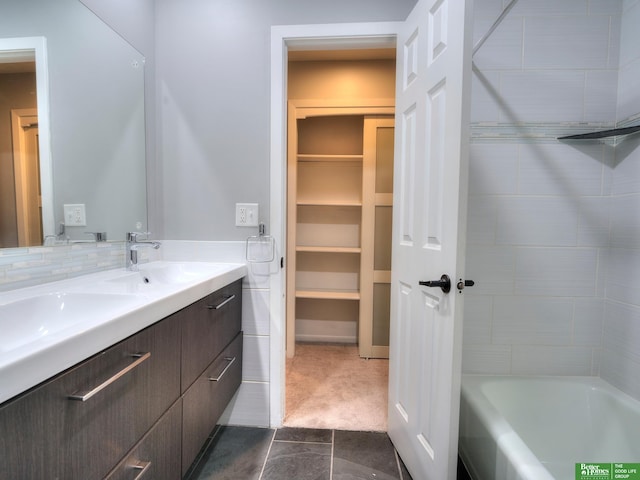 full bathroom featuring double vanity, a sink, walk in shower, and a bath